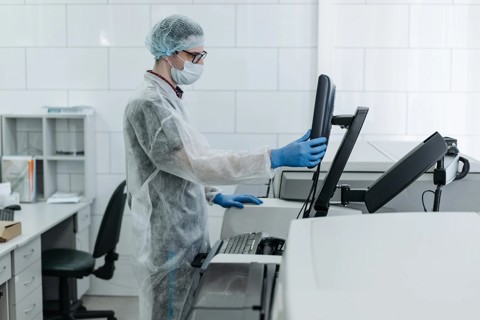Man Wearing Protective Clothing In A Laboratory